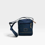 Bolso manos libres kopelletteria azul profundo en cuero genuino con detalles en color miel y correa ajustable.